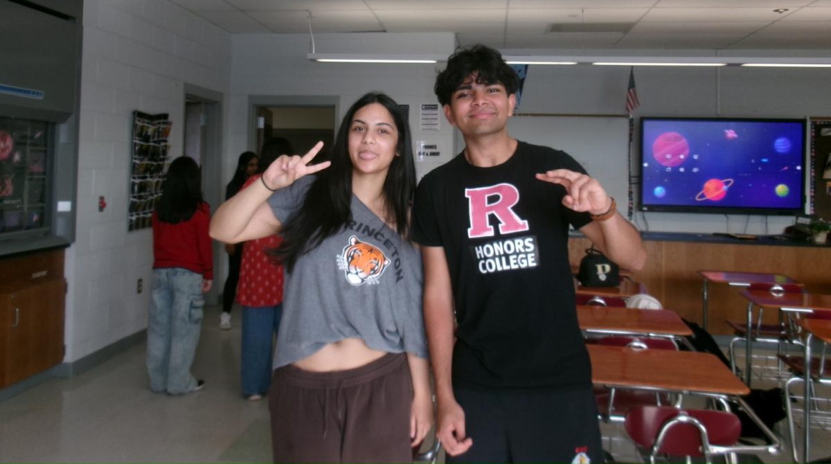 Valedictorian Ishani Bakshi '26 (left) and Salutatorian Hrishi Shah '26 pose in their college gear, crediting their academic success to hands-on learning and proactive study habits.