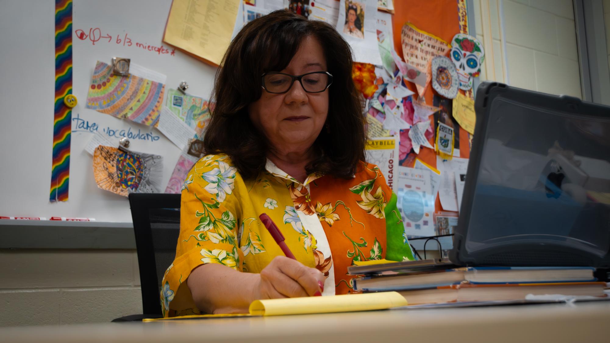 Ms. Marilyn Griswold, seen here grading assignments, has taught all levels of Spanish. She noted her greatest enjoyment was seeing the energy and curiosity of her students 